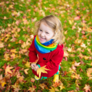 Little girl playing with some leaves